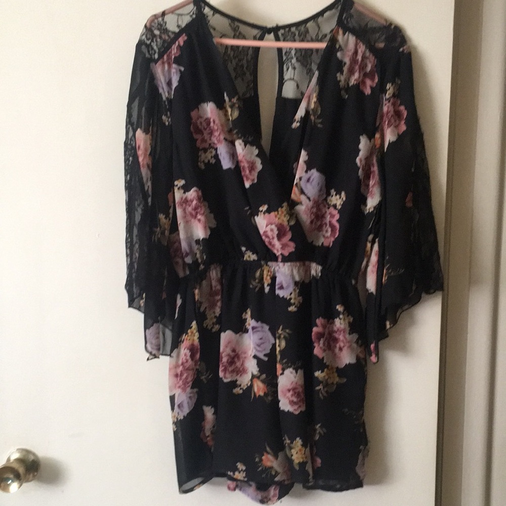 Short jumpsuit black lace detail looks so nice on. In good condition.